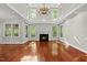 Bright living room featuring a fireplace and hardwood floors at 10825 Rondeau Woods Ct, Raleigh, NC 27614