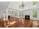 Open-concept living room with fireplace and kitchen access at 10825 Rondeau Woods Ct, Raleigh, NC 27614