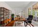 Home office with a large window, desk and built in shelves at 10825 Rondeau Woods Ct, Raleigh, NC 27614