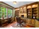 Home office features beautiful built-ins, wood accents and an oversized window at 10825 Rondeau Woods Ct, Raleigh, NC 27614