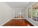 Bright room with hardwood floors and large windows offering views of the porch at 10825 Rondeau Woods Ct, Raleigh, NC 27614