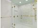 Elegant glass shower featuring gold hardware and neutral tiling at 10825 Rondeau Woods Ct, Raleigh, NC 27614