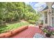 Inviting back deck with string lights, furniture, a grill, and a view of the beautifully landscaped backyard at 109 Hogan Glen Ct, Chapel Hill, NC 27516