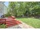 Expansive backyard with a multi-level deck, lush greenery, and stone pathway at 109 Hogan Glen Ct, Chapel Hill, NC 27516