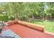 Inviting outdoor space featuring a wooden deck with built-in seating, and a well-maintained lawn at 109 Hogan Glen Ct, Chapel Hill, NC 27516