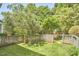 Private backyard with a wooden fence, mature trees, and cozy seating area at 109 Hogan Glen Ct, Chapel Hill, NC 27516