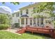 Backyard with a red deck, grill, and stone path amid lush greenery at 109 Hogan Glen Ct, Chapel Hill, NC 27516