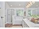 Bright bathroom featuring a soaking tub, glass-enclosed shower, and double vanity at 109 Hogan Glen Ct, Chapel Hill, NC 27516