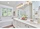 Bright bathroom features double vanity, tub and shower with decor at 109 Hogan Glen Ct, Chapel Hill, NC 27516