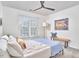 Bright bedroom with a ceiling fan, a bench at the foot of the bed, and a large sunny window at 109 Hogan Glen Ct, Chapel Hill, NC 27516