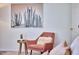 Bedroom sitting area features cactus art print and a soft chair at 109 Hogan Glen Ct, Chapel Hill, NC 27516