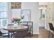 Dining area with wood table, black chairs, modern lighting fixture and view into bathroom at 109 Hogan Glen Ct, Chapel Hill, NC 27516