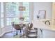 Dining area features a stylish chandelier, large windows, and open floor plan at 109 Hogan Glen Ct, Chapel Hill, NC 27516