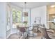 Charming breakfast nook featuring a stylish chandelier and large windows at 109 Hogan Glen Ct, Chapel Hill, NC 27516