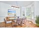 Bright dining room with a glass table, modern chandelier, and large bay window at 109 Hogan Glen Ct, Chapel Hill, NC 27516