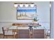 Chic dining room with glass table, decorative light fixture and modern wall art at 109 Hogan Glen Ct, Chapel Hill, NC 27516