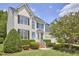 Beautiful two-story home with black shutters, well-maintained landscaping, and a bright blue front door at 109 Hogan Glen Ct, Chapel Hill, NC 27516