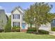 Traditional two-story house with manicured lawn and blue door at 109 Hogan Glen Ct, Chapel Hill, NC 27516