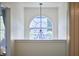 Light-filled foyer with an arched window above a half-wall and a modern light fixture at 109 Hogan Glen Ct, Chapel Hill, NC 27516