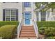 Inviting front entrance with brick steps, white railings, and a cheerful blue front door at 109 Hogan Glen Ct, Chapel Hill, NC 27516