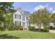 Beautifully landscaped two-story home with a bright blue front door and mature trees at 109 Hogan Glen Ct, Chapel Hill, NC 27516