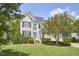 Charming two-story home with manicured lawn, blue front door, and beautiful landscaping at 109 Hogan Glen Ct, Chapel Hill, NC 27516
