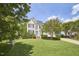 Charming two-story home with manicured lawn, blue front door, and beautiful landscaping at 109 Hogan Glen Ct, Chapel Hill, NC 27516