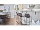Kitchen with counter seating, wood floors and views into the dining area at 109 Hogan Glen Ct, Chapel Hill, NC 27516