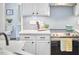 Modern kitchen with white cabinets, stainless steel appliances and fish scale backsplash at 109 Hogan Glen Ct, Chapel Hill, NC 27516