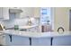Bright kitchen with stainless steel appliances, white cabinets and views into other rooms at 109 Hogan Glen Ct, Chapel Hill, NC 27516