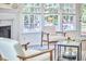 Cozy living room with large windows, comfortable seating, and a view of the outdoor space at 109 Hogan Glen Ct, Chapel Hill, NC 27516
