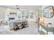 Bright living room boasts a ceiling fan, fireplace, decor, and large windows at 109 Hogan Glen Ct, Chapel Hill, NC 27516