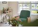 Relaxing living room corner with a stylish bar cart, comfortable chair, and ample natural light at 109 Hogan Glen Ct, Chapel Hill, NC 27516
