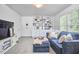 Cozy living room featuring a comfortable blue sofa, custom built-in shelving, and natural lighting at 109 Hogan Glen Ct, Chapel Hill, NC 27516