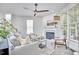 Light filled living room with fireplace, stairs, ceiling fan, and comfortable seating at 109 Hogan Glen Ct, Chapel Hill, NC 27516