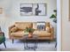 Cozy living room featuring a leather sofa, patterned rug, and contemporary artwork at 109 Hogan Glen Ct, Chapel Hill, NC 27516