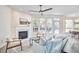 Inviting living room with fireplace, ceiling fan, large windows, and comfortable seating at 109 Hogan Glen Ct, Chapel Hill, NC 27516