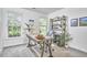 Bright home office features a work desk, shelving unit, and natural light from two large windows at 109 Hogan Glen Ct, Chapel Hill, NC 27516