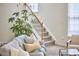 Carpeted staircase with white railings and natural wood banister offers a seamless transition between floors at 109 Hogan Glen Ct, Chapel Hill, NC 27516