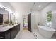 Elegant bathroom featuring a soaking tub, double vanity, and modern design at 109 Lochview Dr, Cary, NC 27518