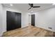 Neutral bedroom with sleek ceiling fan, hardwood floors, and closet; bright and spacious retreat at 109 Lochview Dr, Cary, NC 27518