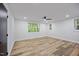 Bright bedroom with hardwood floors, ceiling fan, and scenic views from multiple windows at 109 Lochview Dr, Cary, NC 27518