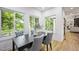 Dining room with a dark wood table and upholstered chairs with views of the outside at 109 Lochview Dr, Cary, NC 27518