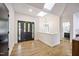 Bright entryway with a skylight, hardwood floors, and black double doors at 109 Lochview Dr, Cary, NC 27518