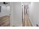 Bright hallway showcasing hardwood floors and white walls, leading into an open room at 109 Lochview Dr, Cary, NC 27518