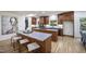 Kitchen featuring an island with seating, stainless steel appliances, and wood floors at 109 Lochview Dr, Cary, NC 27518