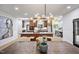 An open kitchen with a large island, stainless steel appliances, and modern lighting with a large connected dining area at 109 Lochview Dr, Cary, NC 27518