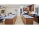 Kitchen featuring a large island with seating, wood cabinets, and wood floors at 109 Lochview Dr, Cary, NC 27518