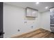 Laundry room featuring wood floors, white cabinets, and laundry hookups for appliances at 109 Lochview Dr, Cary, NC 27518