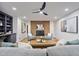 Cozy living room with brick fireplace, modern furnishings, and built-in shelving at 109 Lochview Dr, Cary, NC 27518
